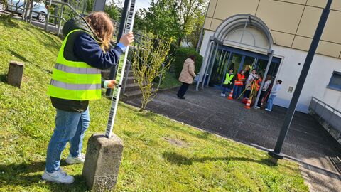 Teilnehmende mit Messutensilien vor dem Eingang