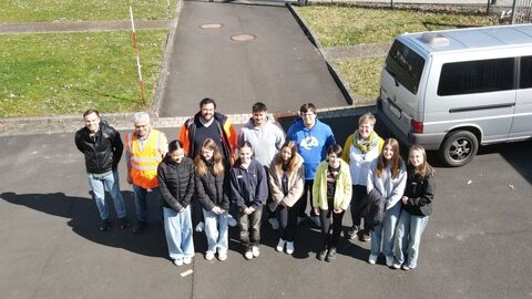 Mehrere Personen auf einem Hof, schräg von oben fotografiert