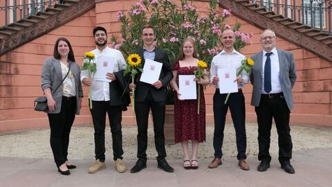 Prüflinge mit Zeugnis und Kollegen vor der Treppe des Biebricher Schlosses